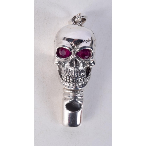 844 - A STERLING SILVER SKULL WHISTLE PENDANT WITH GEM SET EYES.  Stamped 925, 5cm x 1.6cm x 1.9cm, weight... 