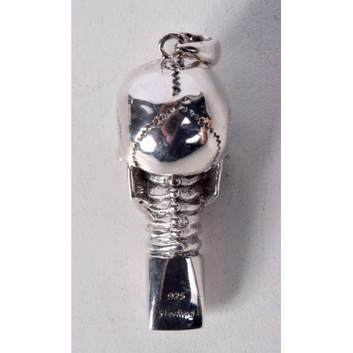 844 - A STERLING SILVER SKULL WHISTLE PENDANT WITH GEM SET EYES.  Stamped 925, 5cm x 1.6cm x 1.9cm, weight... 