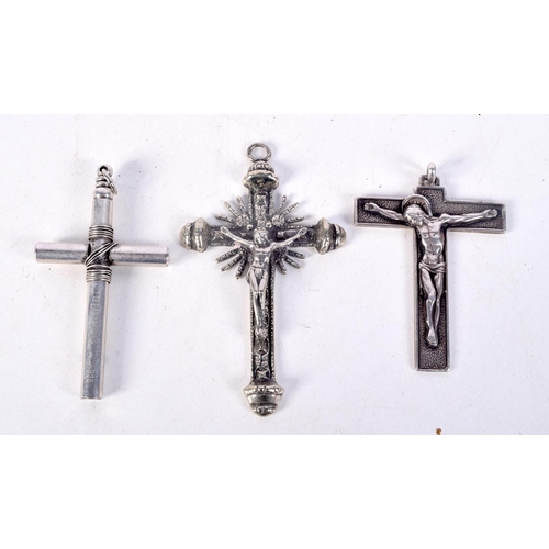 845 - THREE WHITE METAL CRUCIFIXES OF VARIOUS FORMS.  Largest 9.5cm x 5.6cm, total weight 93.1g