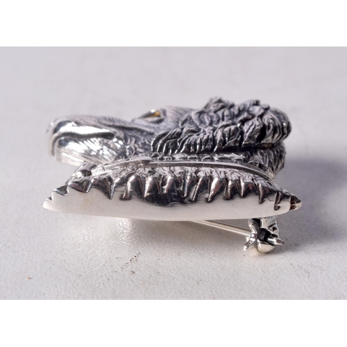 854 - A STERLING SILVER DOG BROOCH WITH A GEM SET EYE.  Stamped Sterling, 2.9cm x 3cm, weight 11.2g