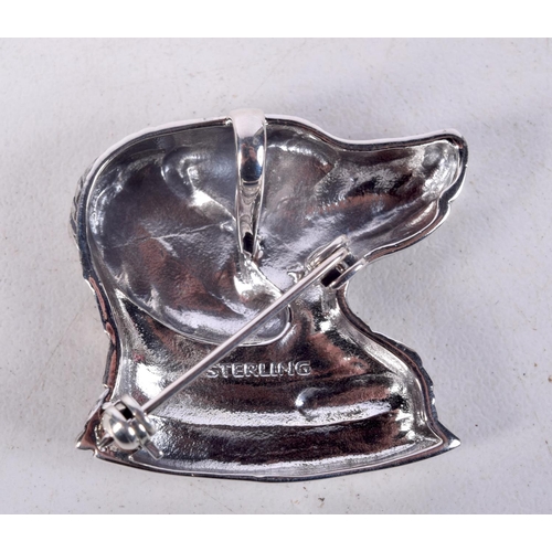 854 - A STERLING SILVER DOG BROOCH WITH A GEM SET EYE.  Stamped Sterling, 2.9cm x 3cm, weight 11.2g