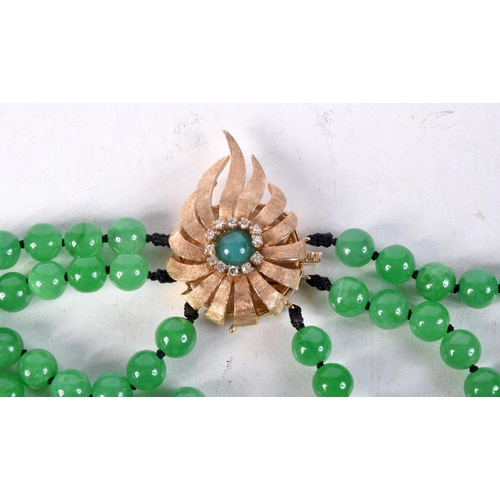 857 - A THREE STRAND GREEN JADE NECKLACE WITH A GOLD CLASP SET WITH DIAMONDS.  Marked MGM, length 55cm, Be... 