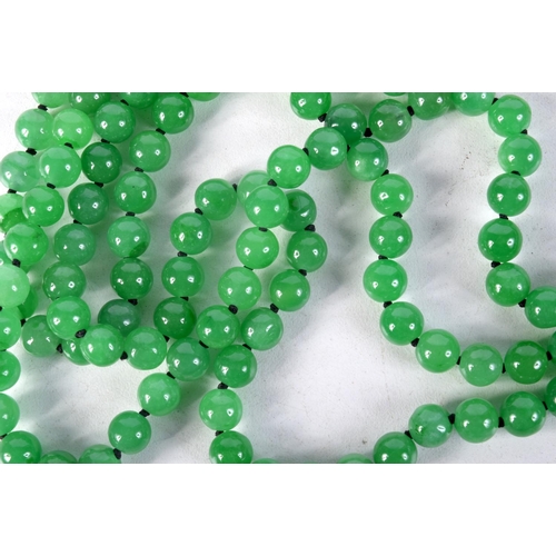 857 - A THREE STRAND GREEN JADE NECKLACE WITH A GOLD CLASP SET WITH DIAMONDS.  Marked MGM, length 55cm, Be... 