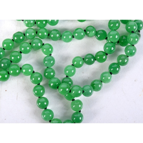 857 - A THREE STRAND GREEN JADE NECKLACE WITH A GOLD CLASP SET WITH DIAMONDS.  Marked MGM, length 55cm, Be... 