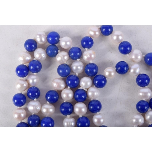 867 - A BEAD NECKLACE WITH PEARLESCENT AND BLUE STONE BEADS.  Length 120cm, bead size 7.1mm