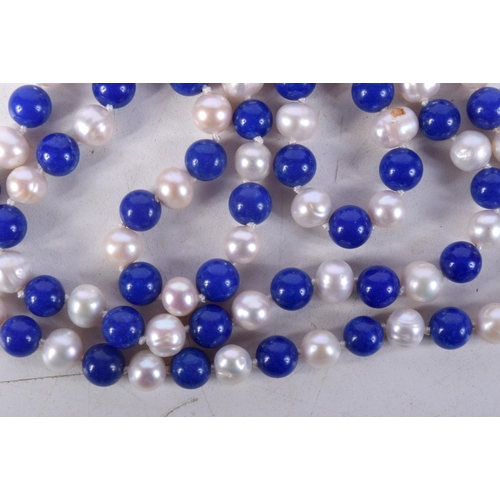 867 - A BEAD NECKLACE WITH PEARLESCENT AND BLUE STONE BEADS.  Length 120cm, bead size 7.1mm