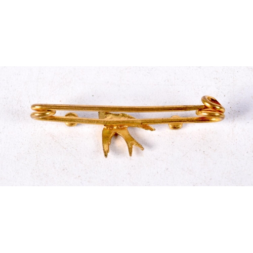 888 - A VICTORIAN BAR BROOCH WITH A SWALLOW AND SET WITH GEMS.  3.3cm x 1cm, weight 1g