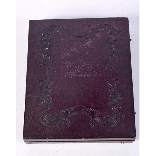 890 - A LEATHER BOUND CASED PAIR OF TINTED DAGUERREOTYPES OF A SEATED VICTORIAN GENTLEMAN AND HIS WIFE.  1... 