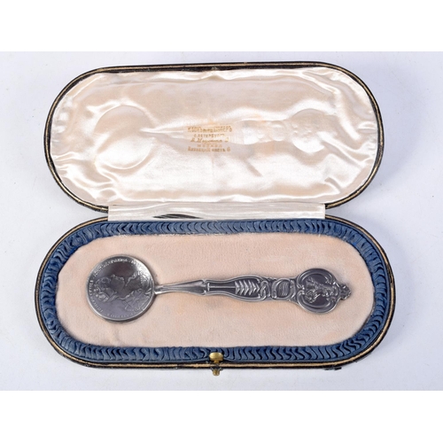 891 - A CONTINENTAL SILVER CASED COIN SPOON.  Stamped 84, 14.3cm x 3.8cm, weight of spoon 58g