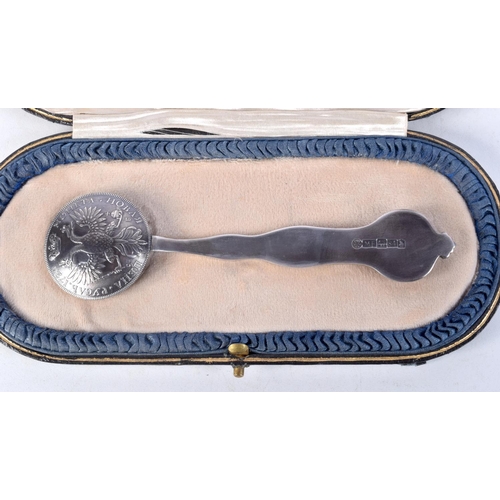 891 - A CONTINENTAL SILVER CASED COIN SPOON.  Stamped 84, 14.3cm x 3.8cm, weight of spoon 58g