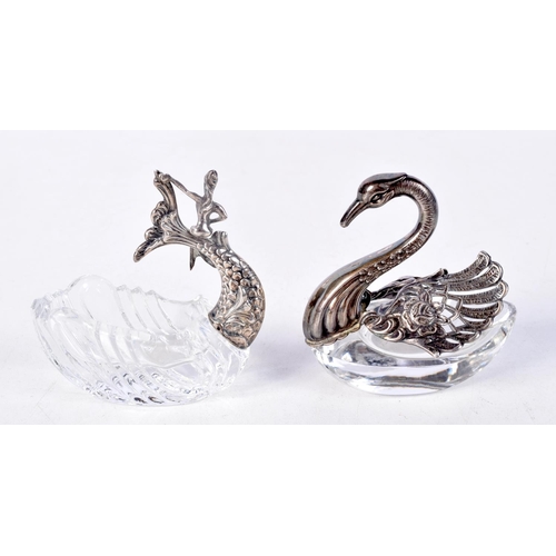 902 - TWO GLASS TABLE SALTS WITH WHITE METAL FITTINGS.  MODELLED AS A DOLPHIN AND A SWAN.  7cm x 7cm x 4cm... 