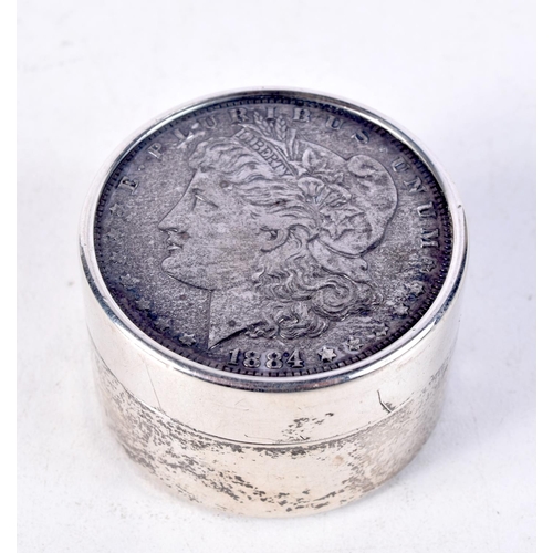 919 - A STERLING SILVER COIN BOX WITH A US DOLLAR IN THE COVER.  Stamped Sterling, 4cm x 2.5cm, weight 71g