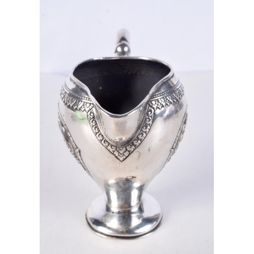 931 - A 19TH CENTURY SOUTH EAST ASIAN CHINESE TIBETAN SILVER JUG decorated with buddhistic figures. 153 gr... 