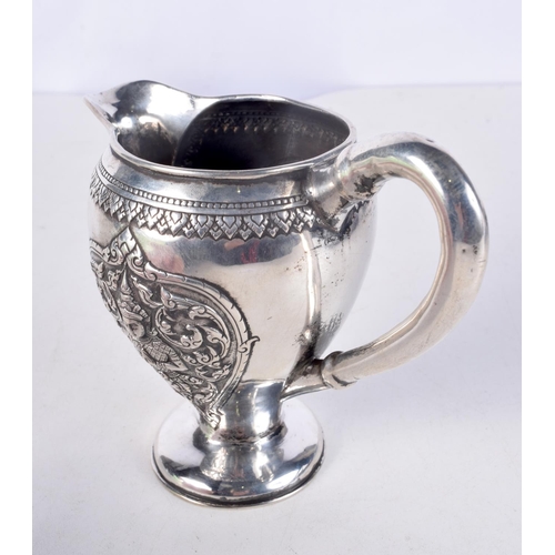 931 - A 19TH CENTURY SOUTH EAST ASIAN CHINESE TIBETAN SILVER JUG decorated with buddhistic figures. 153 gr... 