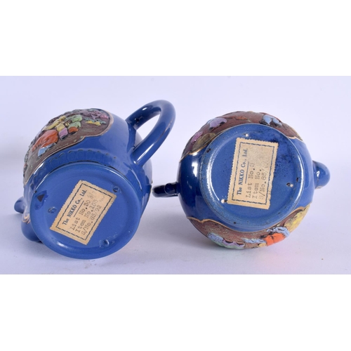 1501 - AN UNUSUAL PAIR OF JAPANESE TAISHO PERIOD NIKKI COMPANY LTD POTTERY TEAPOTS decorated with figures. ... 