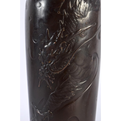 1548 - A 19TH CENTURY JAPANESE MEIJI PERIOD SLENDER BRONZE VASE by Jyoun, decorated with a dragon with gold... 