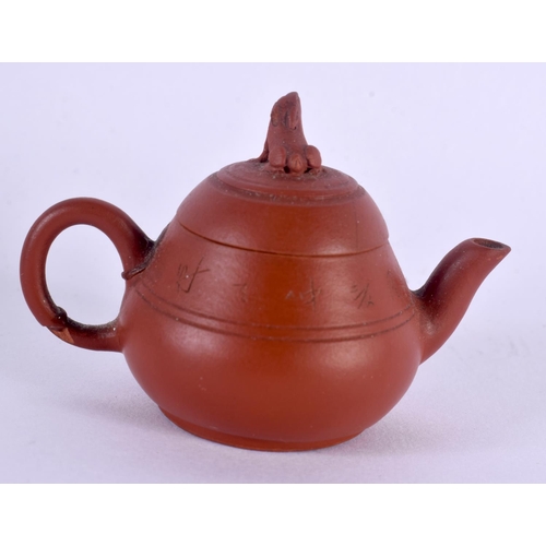 1569 - A RARE MINIATURE LATE 19TH/20TH CENTURY CHINESE YIXING POTTERY TEAPOT AND COVER decorated with calli... 