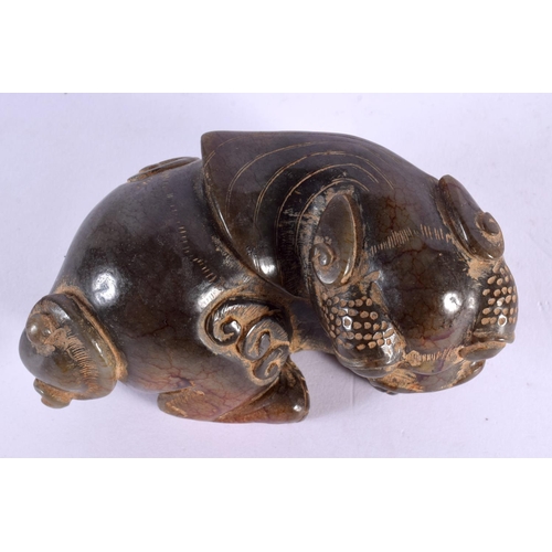 1634 - A CHINESE CARVED JADE FIGURE OF A BUDDHISTIC BEAST 20th Century. 12 cm x 7 cm.