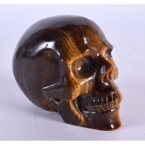 1635 - A CHINESE CARVED TIGERS EYE SKULL 20th Century. 8 cm x 6 cm.