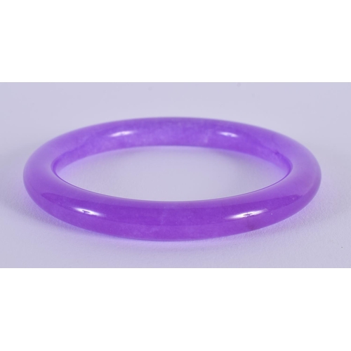 1648 - A CHINESE CARVED LAVENDER JADE BANGLE 20th Century. 7.5 cm diameter.