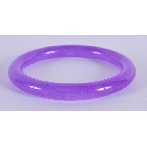 1648 - A CHINESE CARVED LAVENDER JADE BANGLE 20th Century. 7.5 cm diameter.