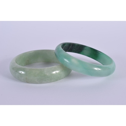 1652 - A PAIR OF CHINESE CARVED JADEITE BANGLES 20th Century. 6.5 cm diameter.