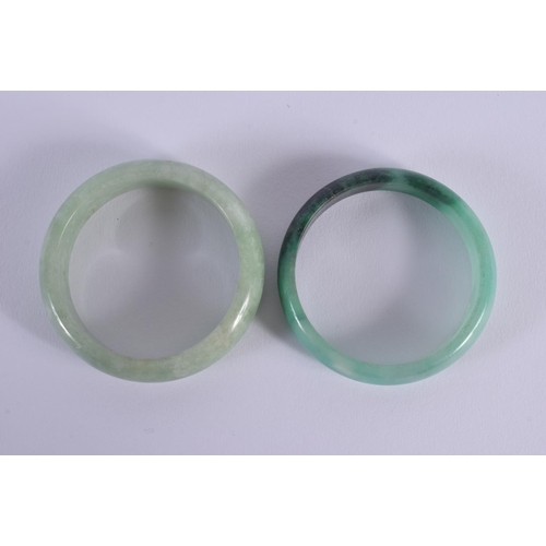 1652 - A PAIR OF CHINESE CARVED JADEITE BANGLES 20th Century. 6.5 cm diameter.