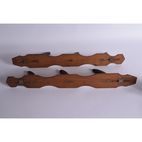 1670 - A PAIR OF 19TH CENTURY MIDDLE EASTERN CARVED HORN COAT RACKS upon wooden plinths. 50 cm long.