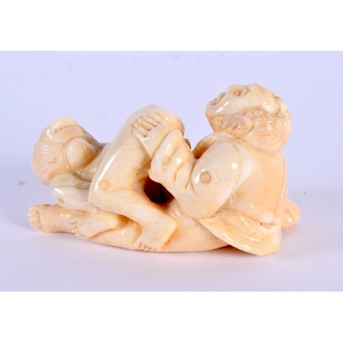 1677 - A JAPANESE CARVED BONE EROTIC NETSUKE. 5.5 cm x 2.5 cm.