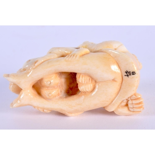 1677 - A JAPANESE CARVED BONE EROTIC NETSUKE. 5.5 cm x 2.5 cm.