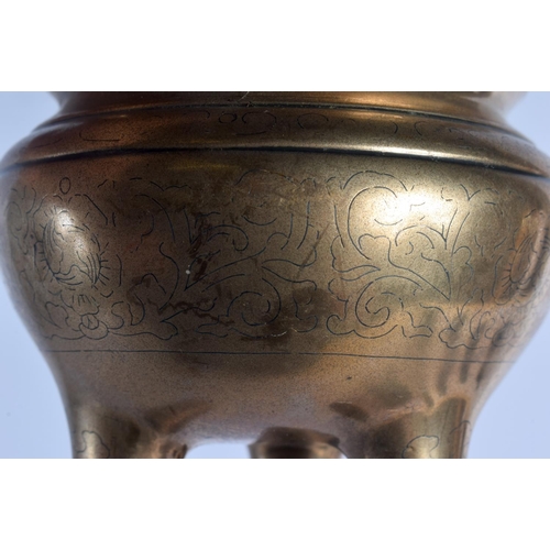 1682 - A 19TH CENTURY CHINESE TWIN HANDLED BRONZE CENSER Qing, engraved with motifs and vines. 681 grams. 1... 