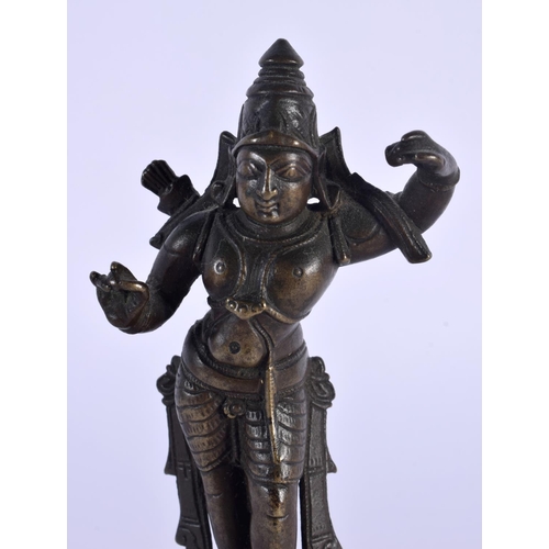 1699 - A 19TH CENTURY MIDDLE EASTERN INDIAN BRONZE DEITY upon a wooden plinth. 14 cm high.