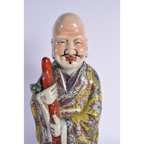 1740 - A LARGE CHINESE REPUBLICAN PERIOD FAMILLE ROSE FIGURE embellished in floral robes. 45 cm high.