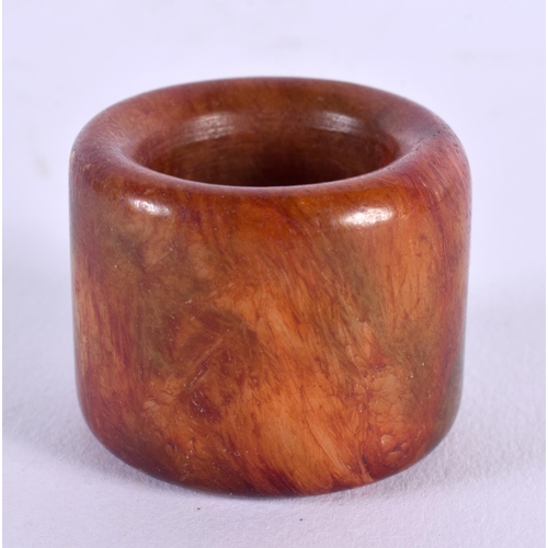 1756 - A CHINESE CARVED HORN AGATE ARCHERS RING 20th Century. 2.25 cm wide.