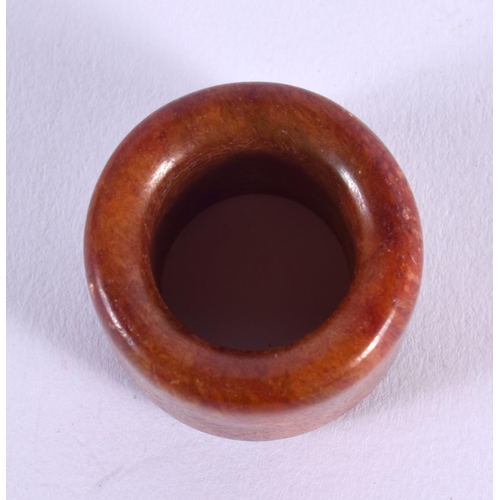 1756 - A CHINESE CARVED HORN AGATE ARCHERS RING 20th Century. 2.25 cm wide.