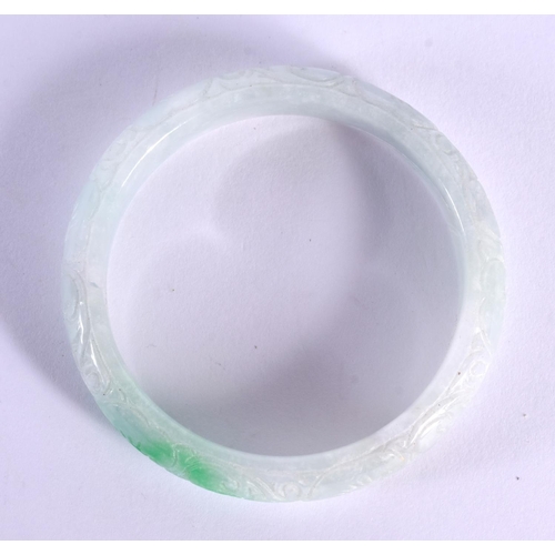 1891 - A CHINESE CARVED JADE BANGLE 20th Century. 5.75 cm diameter.