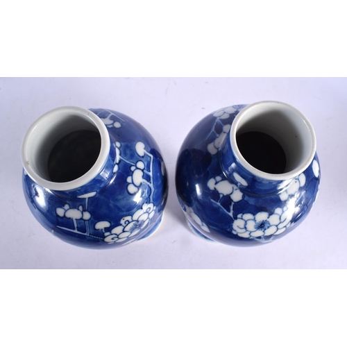 2032 - A PAIR OF 19TH CENTURY CHINESE BLUE AND WHITE VASES bearing Kangxi marks to base. 24 cm high.