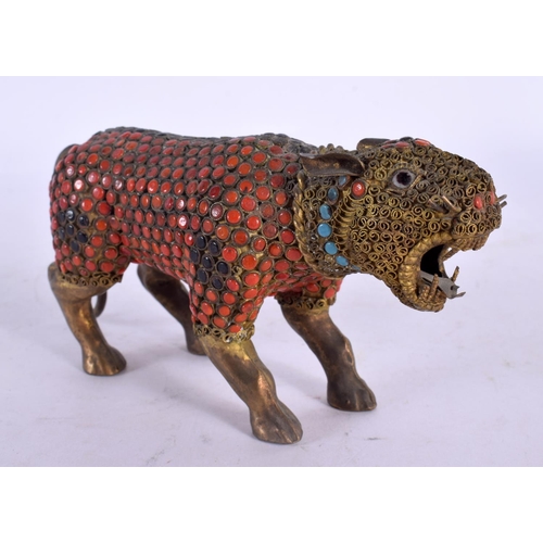 2062 - A 19TH CENTURY TIBETAN GILT METAL CORAL FIGURE OF A BEAST modelled scowling. 15 cm wide.