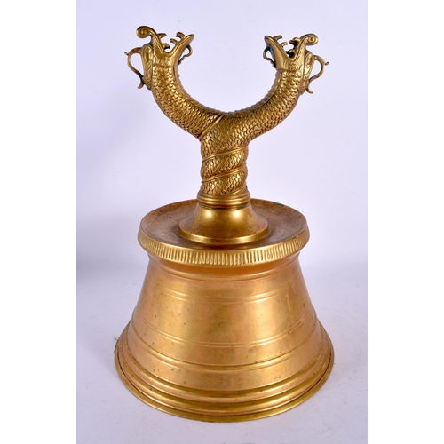 2070 - A VERY RARE ISLAMIC OTTOMAN BRONZE CANDLESTICK formed with open work dragons. 30 cm x 12 cm.