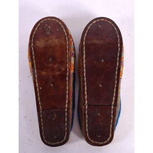 2120 - A PAIR OF 19TH CENTURY CHINESE SILKWORK EMBROIDERED SHOES Qing. 22 cm long.