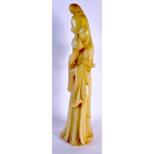 2141 - A LARGE 19TH CENTURY CHINESE CARVED GREEN JADE FIGURE OF A FEMALE modelled holding a flower. 38 cm h... 