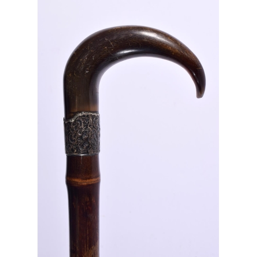 2155 - AN ANTIQUE SILVER MOUNTED CARVED RHINOCEROS HORN WALKING CANE. 90 cm long.