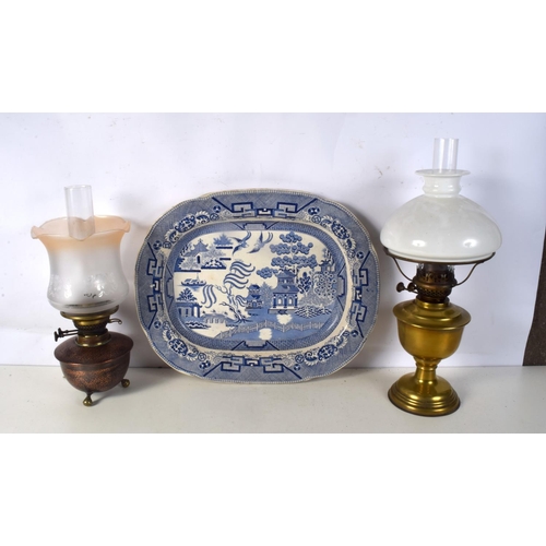 3713 - A collection of Oil lamps together with a ceramic platter.51 x 41 cm. (3).