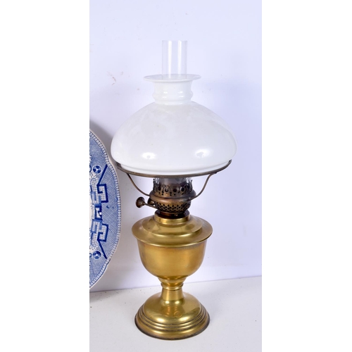 3713 - A collection of Oil lamps together with a ceramic platter.51 x 41 cm. (3).