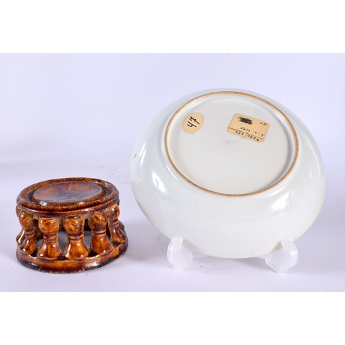 1840 - A CHINESE TREACLE GLAZED STAND 20th Century, and a Qianlong saucer. Largest 8 cm diameter. (2)