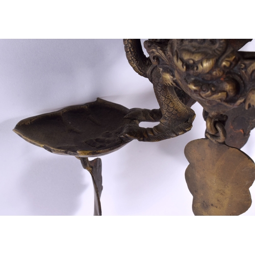 1867 - A RARE 19TH CENTURY INDIAN TIBETAN BRONZE HANGING BUDDHISTIC OIL BURNER formed with dragons and mask... 