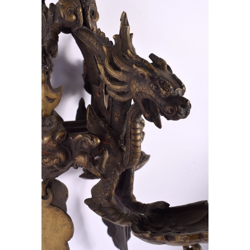 1867 - A RARE 19TH CENTURY INDIAN TIBETAN BRONZE HANGING BUDDHISTIC OIL BURNER formed with dragons and mask... 