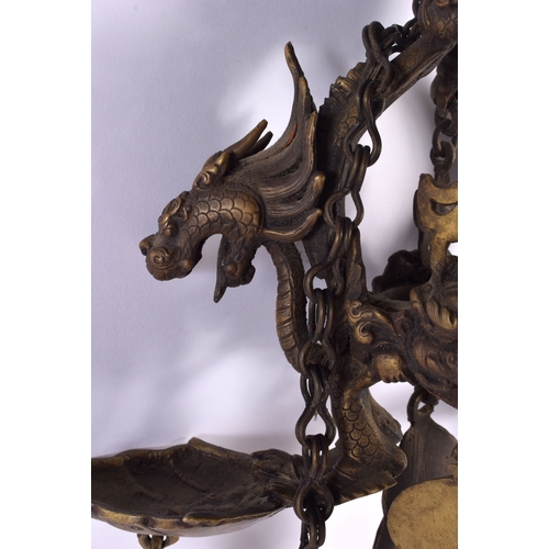 1867 - A RARE 19TH CENTURY INDIAN TIBETAN BRONZE HANGING BUDDHISTIC OIL BURNER formed with dragons and mask... 