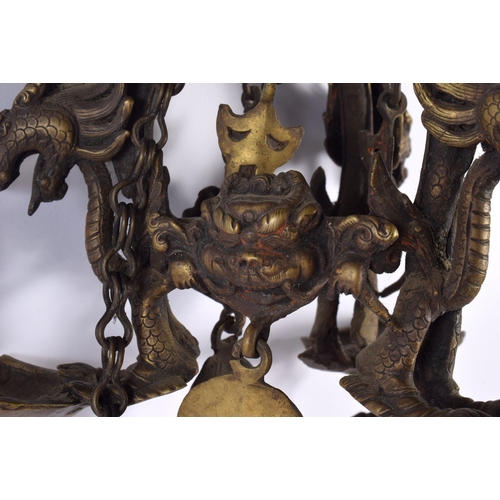 1867 - A RARE 19TH CENTURY INDIAN TIBETAN BRONZE HANGING BUDDHISTIC OIL BURNER formed with dragons and mask... 