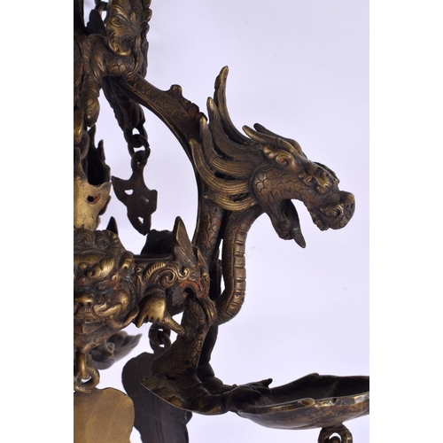 1867 - A RARE 19TH CENTURY INDIAN TIBETAN BRONZE HANGING BUDDHISTIC OIL BURNER formed with dragons and mask... 